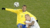 [Jay DeMerit of the U.S, right, vies for the ball with Brazil's Luis Fabiano during the Confederations Cup final soccer match.]